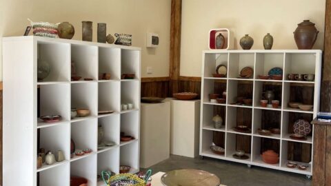 Two cabinets filled with pottery items.